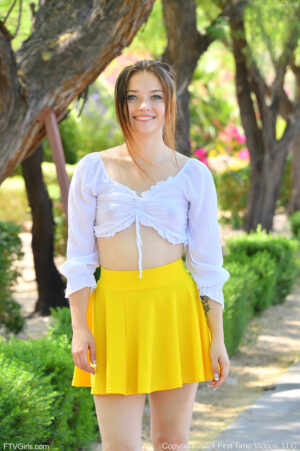 Freckle faced tiny little thing Olivia frolics in a yellow skirt giving upskirt peeks in the park